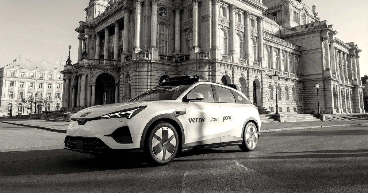 A white autonomous electric vehicle branded with Verne, Uber, and Pony.ai parked in front of a grand building.