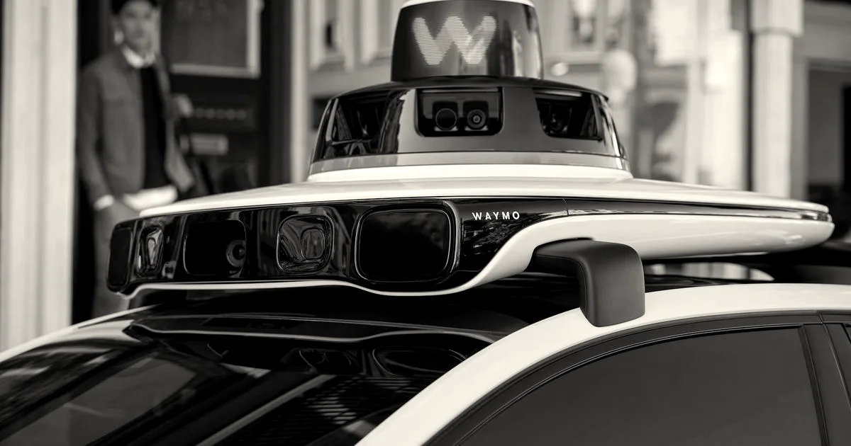Close-up view of the sensor suite mounted on the roof of a white Waymo autonomous vehicle