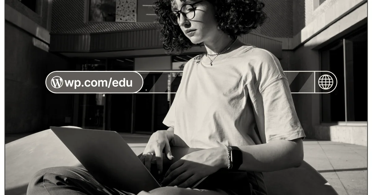 A young woman wearing glasses and a pink shirt works on a laptop outdoors under bright sunlight.