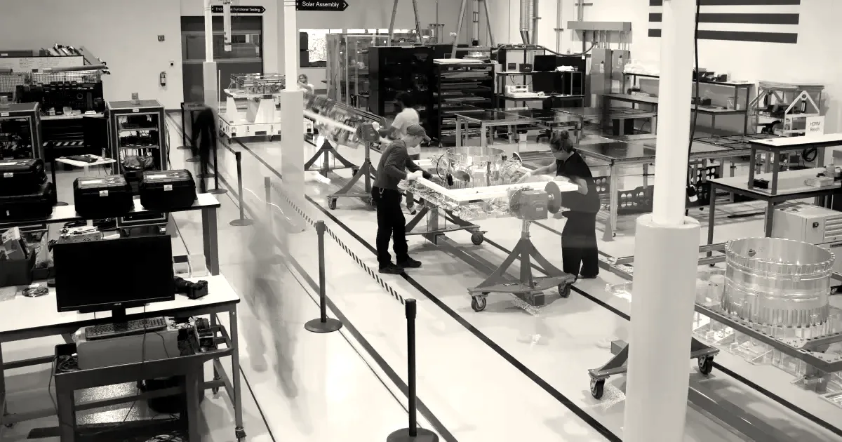 Engineers and technicians assemble satellites on a clean manufacturing facility floor at Xona Space Systems.