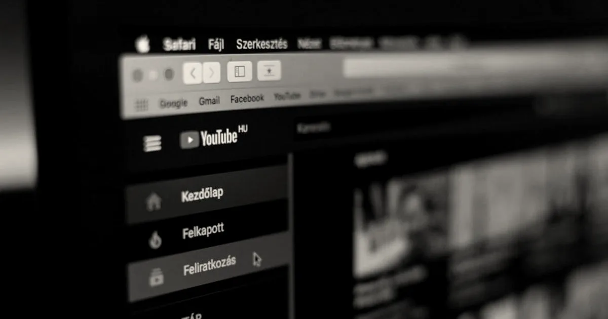 Close-up of a computer monitor displaying the YouTube homepage interface in a web browser